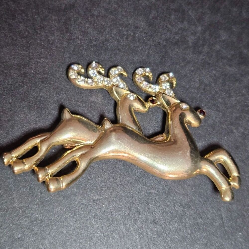 Gold tone prancing reindeer holiday brooch